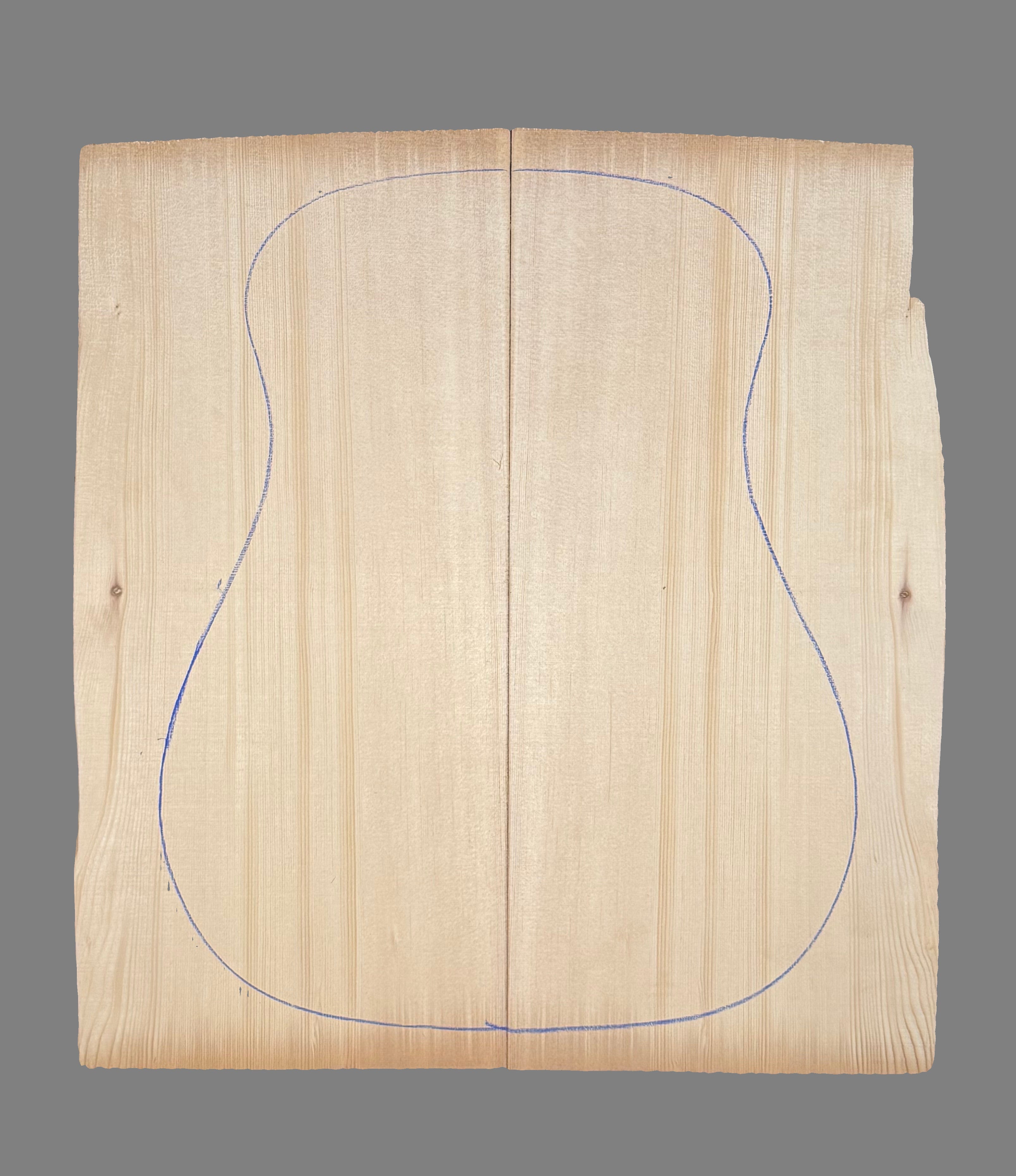 Wooden guitar soundboard with blue outline on a black background